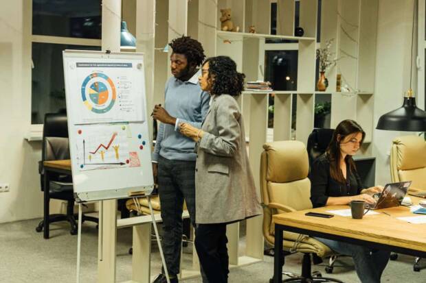 2 people in fromt of a whiteboard